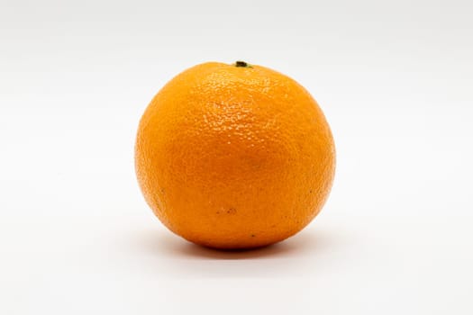 A closeup of a tangerine on a white background