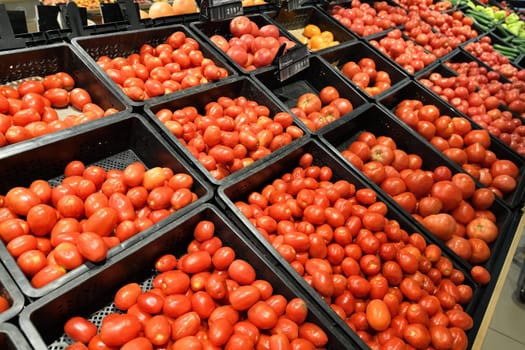 Shop window with tomatoes in the plastic boxes