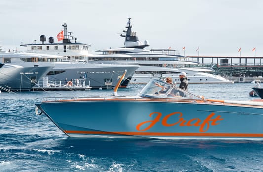 Monaco, Monte Carlo, 29 September 2022 - Water taxi by luxury motorboat on the famous yacht exhibition, a lot of most expensive luxury yachts, richest people, yacht brokers, boat traffic. High quality photo