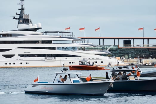 Monaco, Monte Carlo, 29 September 2022 - Water taxi by luxury motorboat on the famous yacht exhibition, a lot of most expensive luxury yachts, richest people, yacht brokers, boat traffic. High quality photo