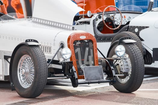 vintage open-top car at the yacht show in Monaco on a sunny day, leather seats, spoked wheels, close-up. High quality photo