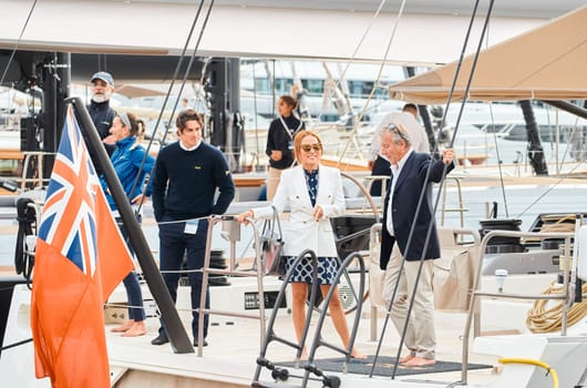 Monaco, Monte Carlo, 29 September 2022 - Invited wealthy clients inspect mega yachts at the largest fair exhibition in the world yacht show MYS, port Hercules, yacht brokers, sunny weather. High quality photo