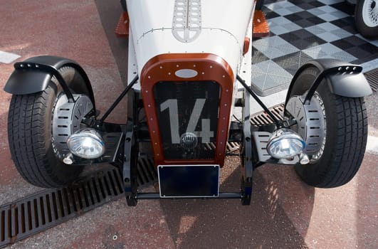 vintage open-top car at the yacht show in Monaco on a sunny day, leather seats, spoked wheels, close-up. High quality photo