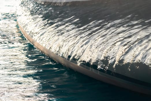 Sun glare on glossy board of mega yacht, anchor, tranquillity in port Hercules, bow of moored huge boat at sunny day, Monaco, Monte-Carlo. High quality photo