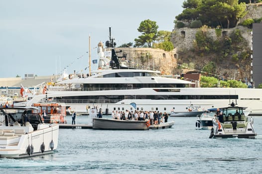 Monaco, Monte Carlo, 29 September 2022 - Water taxi by luxury motorboat on the famous yacht exhibition, a lot of most expensive luxury yachts, richest people, yacht brokers, boat traffic. High quality photo