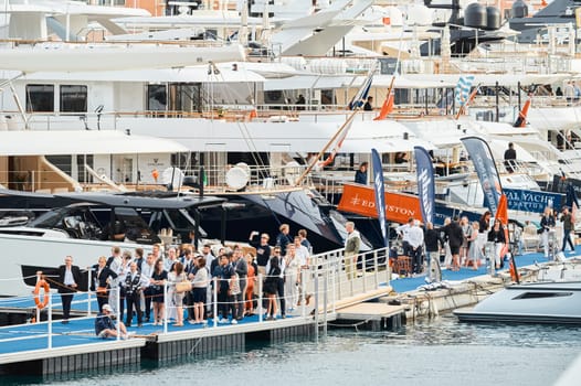 Monaco, Monte Carlo, 29 September 2022 - The famous motorboat exhibition, mega yacht show, clients and yacht brokers discuss the novelties of the boating industry, look at the mega yachts presented. High quality photo