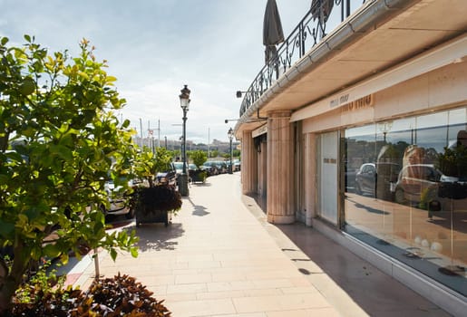 Monaco, Monte-Carlo, 29 September 2022: An empty gallery with branded shops next to the Paris hotel on a sunny day, the window of the Miu Miu store, nobody. High quality photo