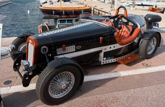 Monaco, Monte-Carlo, 29 September 2022: vintage open-top car at the yacht show on a sunny day, leather seats, spoked wheels, close-up. High quality photo