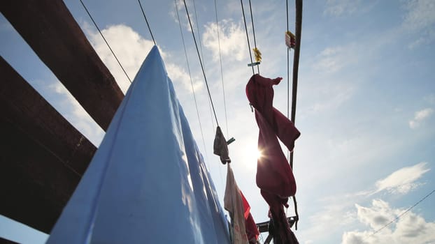 Clothes are drying against a blue sunny sky