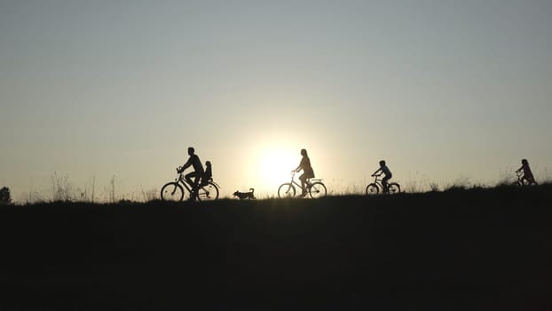 A friendly large family with bicycles at sunset