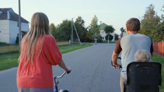 A loving couple on bicycles in the evening