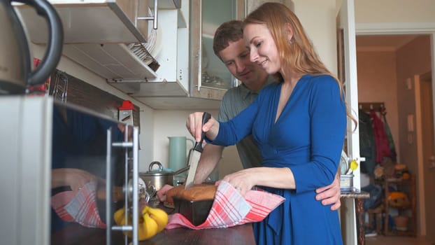Loving husband communicates with his wife in the kitchen