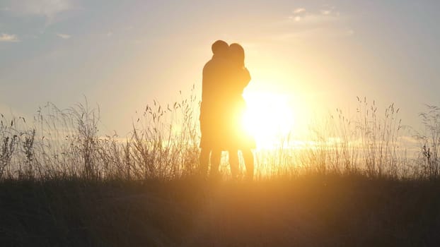 Beautiful young couple at sunset hugging tenderly