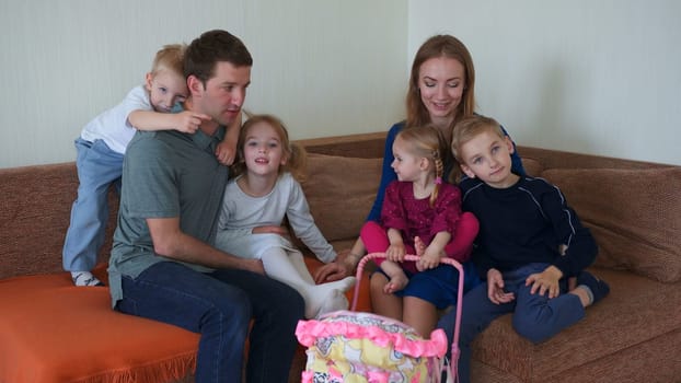 Big friendly family on the couch in their house