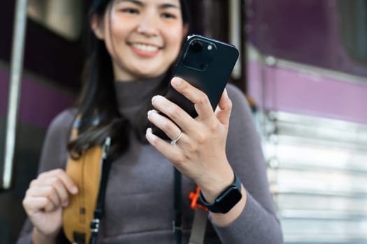 Woman using mobile phone for looking at map while travel by train. travel concept.