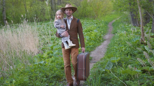 Father with a little daughter goes on a trip