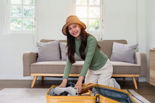 Woman packing a suitcase for a new travel trip. bag and luggage for journey.