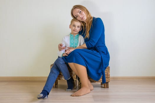 Happy young mother with her son in national Russian clothes