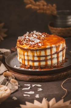 Delicious caramel cake with small pieces of pecan nuts and coconut shavings.