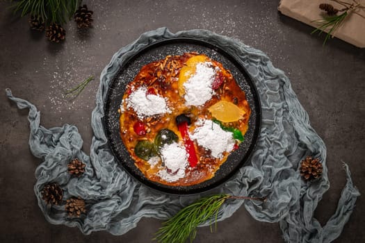 Bolo Rei or Kings Cake is a traditional Xmas cake with fruits raisins nut and icing on kitcthen countertop. Is made for Christmas, Carnavale or Mardi Gras