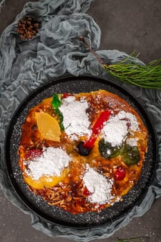 Bolo Rei or Kings Cake is a traditional Xmas cake with fruits raisins nut and icing on kitcthen countertop. Is made for Christmas, Carnavale or Mardi Gras