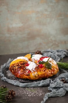 Bolo Rei or Kings Cake is a traditional Xmas cake with fruits raisins nut and icing on kitcthen countertop. Is made for Christmas, Carnavale or Mardi Gras