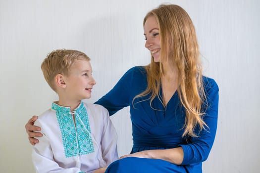 Happy young mother with her son in national Russian clothes