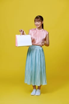 Excited smile Asian woman looking mobile phone holding shopping bag show credit card payment banking shopping online