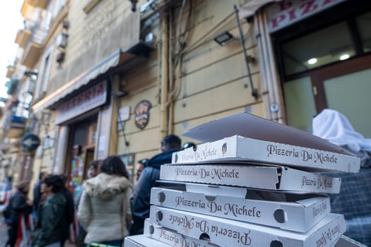 Napoli, Italy: 2023 November 18: People waiting on the street at La Antica Pizzeria Da Michele from 1870 where the authentic Margherita pizza is made in November 2023.