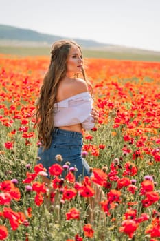 Woman poppies field. Side view of a happy woman with long hair in a poppy field and enjoying the beauty of nature in a warm summer day