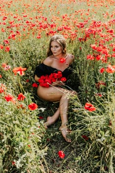 Woman poppies field. portrait of a happy woman with long hair in a poppy field and enjoying the beauty of nature in a warm summer day