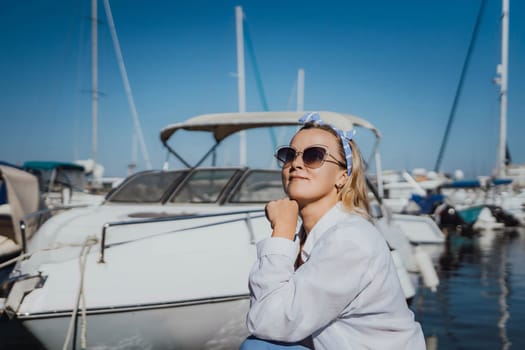 Woman in white shirt in marina , surrounded by several other boats. The marina is filled with boats of various sizes, creating a lively and picturesque atmosphere