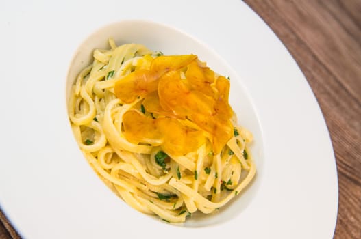 LINGUINE PASTA RECIPE WITH POUTARGUE, LEMON, GARLIC, LEMON ZEST, FRESH CREAM AND PARSLEY. High quality photo