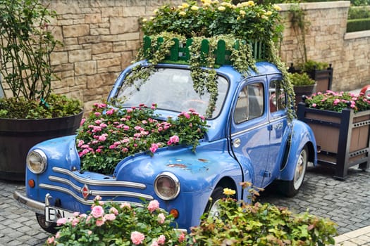 Vintage car decorated with flowers in the photo zone in a romantic style. High quality photo