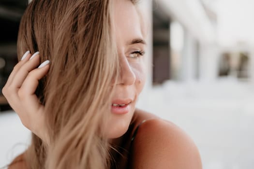 Happy woman portrait in cafe. Boho chic fashion style. Outdoor photo of young happy woman with long hair, sunny weather outdoors sitting in modern cafe