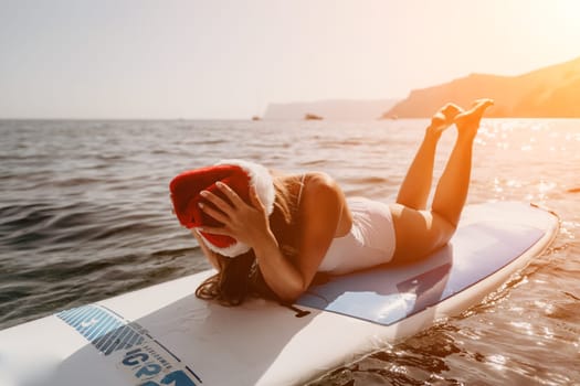 Close up shot of happy young caucasian woman looking at camera and smiling. Cute woman portrait in bikini posing on a volcanic rock high above the sea