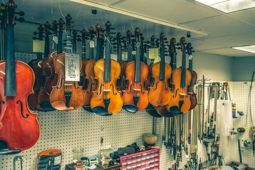 violins are handing in a luter shop ready for finishing