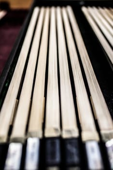 Many violin bows are laying in a row