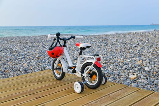Children bicycle at the beach of the ocean