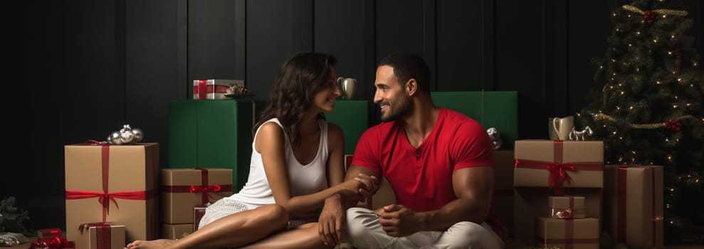 Relaxing in new house. Cheerful young couple sitting on the floor while cardboard boxes laying all around them. High quality photo