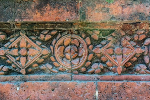 Terracotta patterns ancient stone carving, pattern on stone wall of Bagha Shahi Mosque