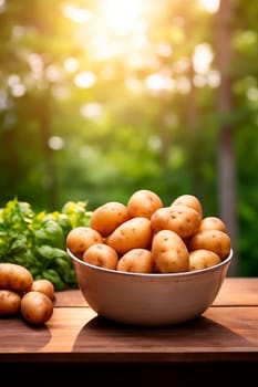 Potatoes in a bowl against the backdrop of the garden. Selective focus. Food.