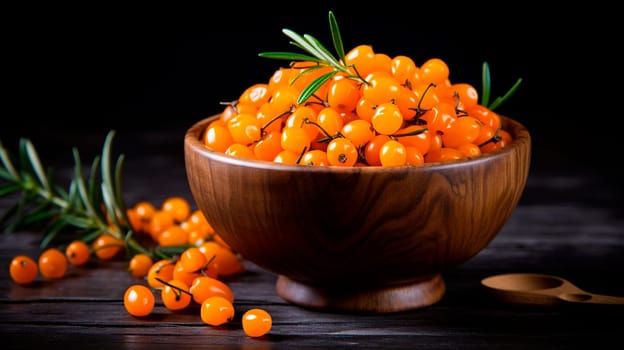 Sea buckthorn in a bowl against the backdrop of the garden. Selective focus. Food.