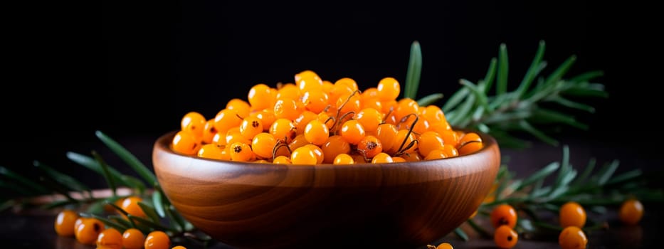 Sea buckthorn in a bowl against the backdrop of the garden. Selective focus. Food.