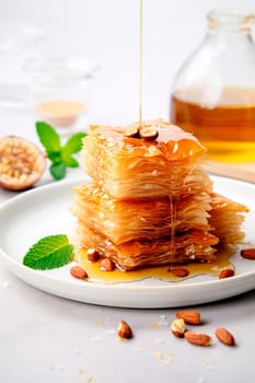 Baklava with nuts and honey on the table. Selective focus. Food.