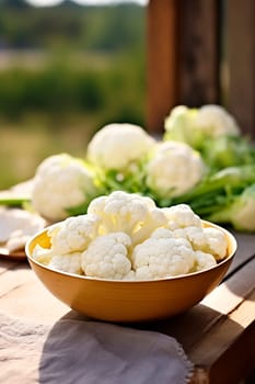 Cauliflower in a bowl against the backdrop of the garden. Selective focus. Nature.