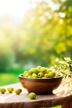 Olives in a bowl against the backdrop of the garden. Selective focus. Food.