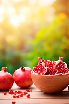 Pomegranates in a bowl in the garden. Selective focus. Food.