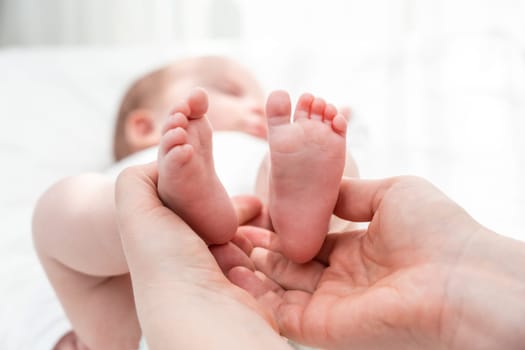 In the hands of a mother, the little feet of her baby find comfort and security