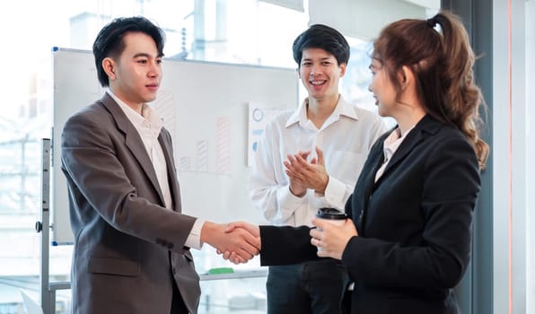 Young business people shaking hands in the office. Finishing successful meeting..